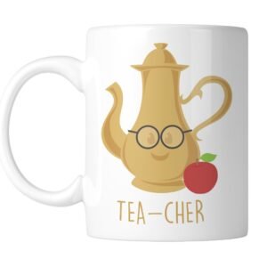 White mug with a gold teapot wearing glasses, an apple and “Tea-Cher”, handle on the left