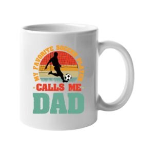 White mug with a footballer in silhouette on a retro sunset with “My favorite soccer player calls me Dad”