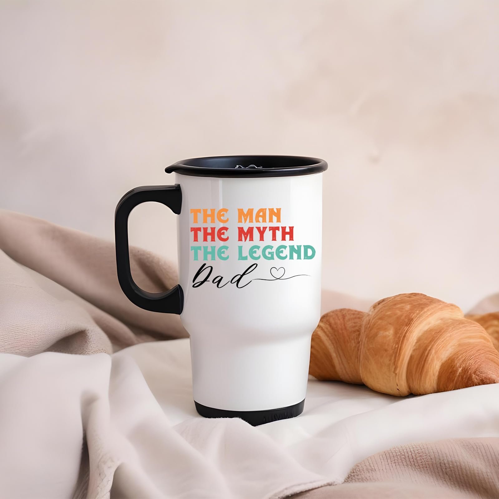 61f6ta6dicl.jpg The Man the Myth Dad travel mug on a soft blanket beside a croissant