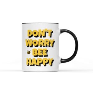 White mug with a black handle and “Don't worry bee happy” in yellow letters