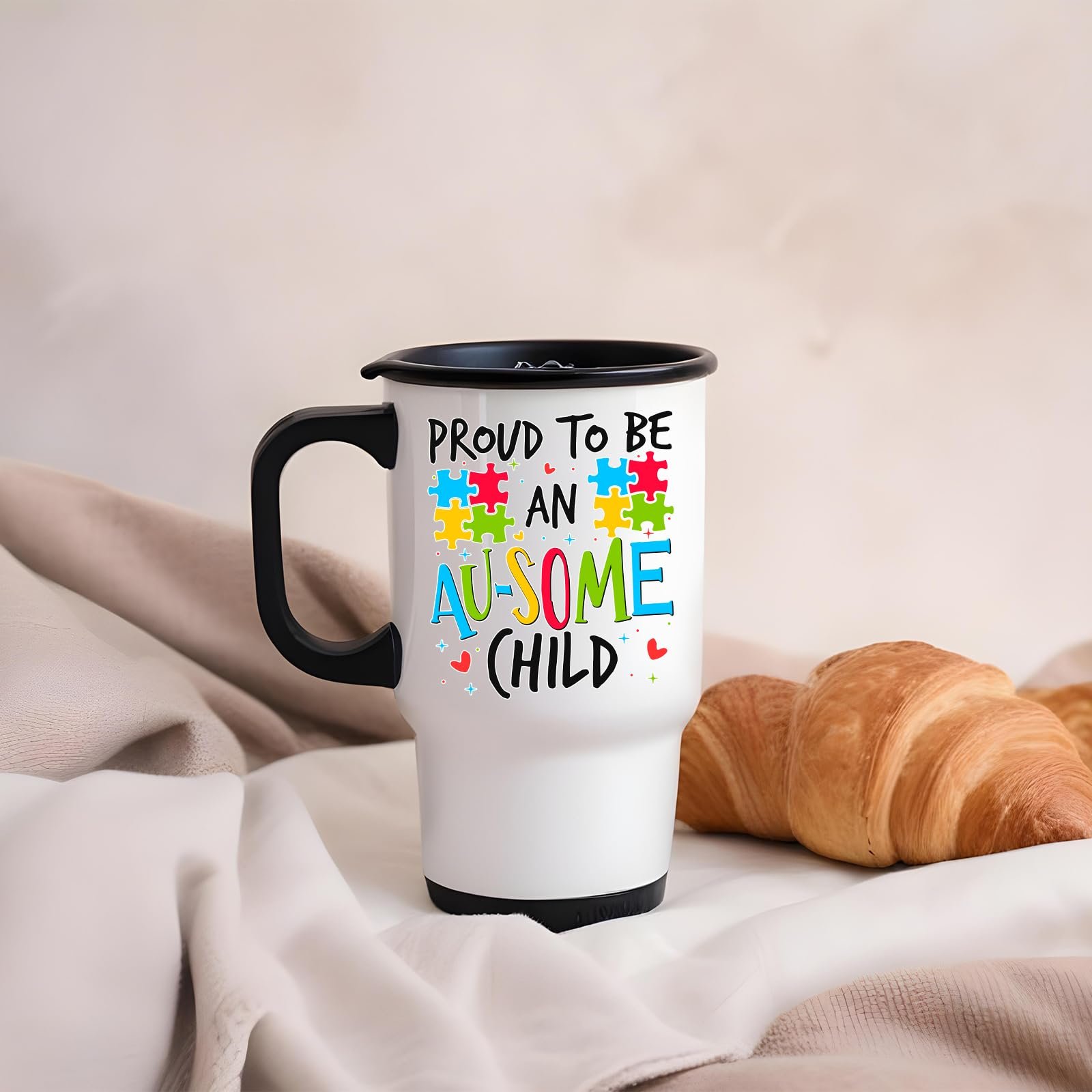 61a2bohmtel.jpg Proud to Be an Au-Some Child travel mug on a soft blanket beside a croissant