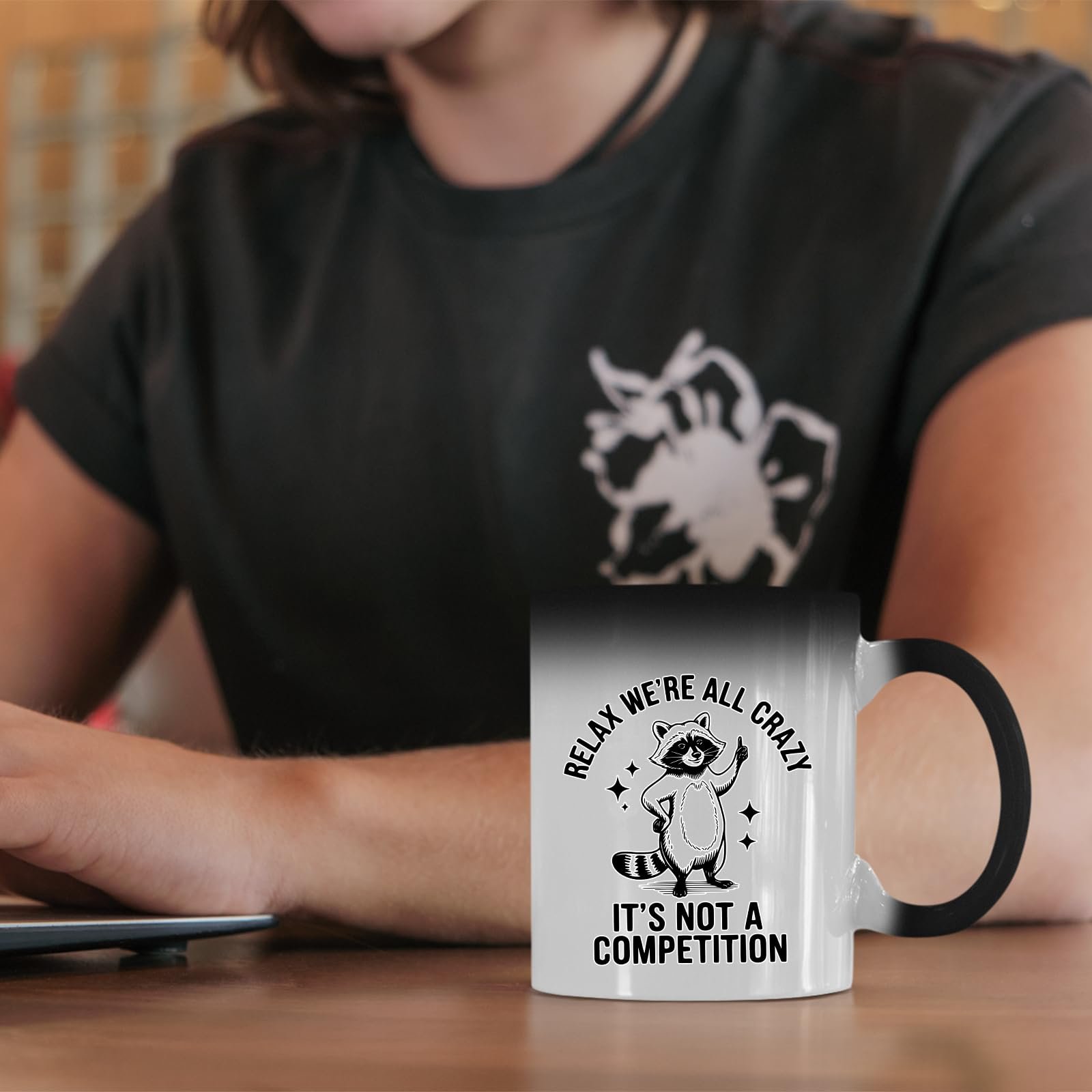 61vlwn43e8l.jpg Relax We’re All Crazy raccoon colour changing mug on a desk beside a laptop
