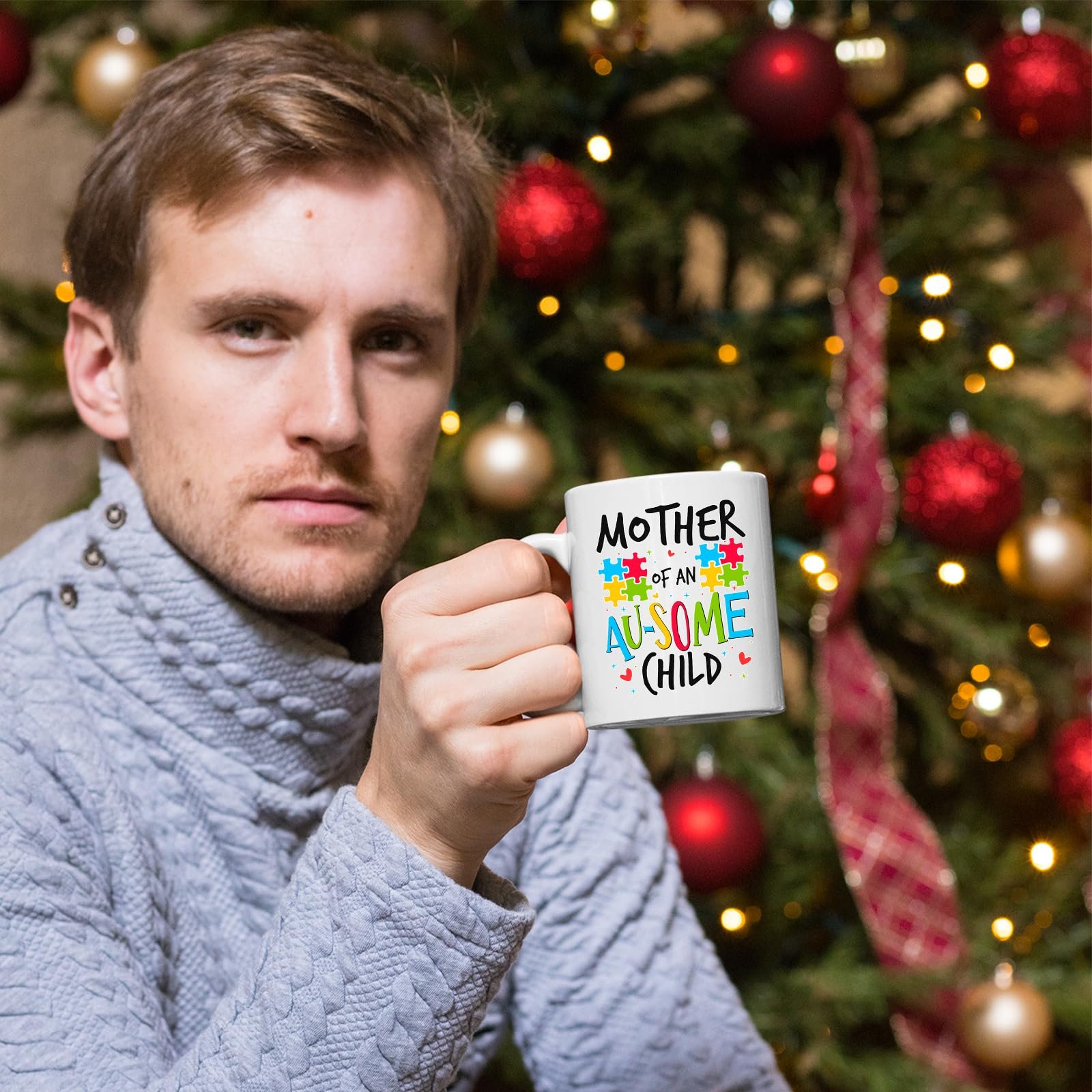 71 f15dtapl.jpg Man holding the Mother of an Au-Some Child mug in front of a Christmas tree