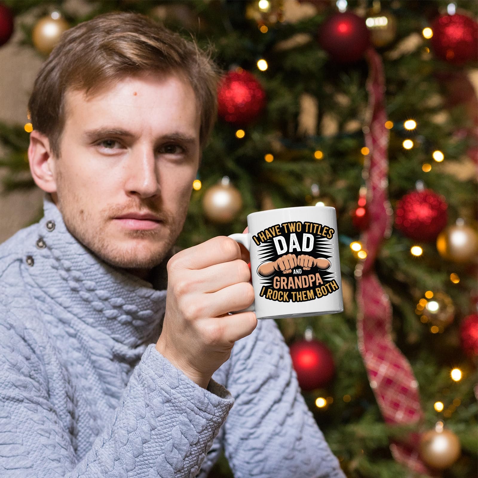 717c2vibmzl.jpg Man holding the Two Titles Dad and Grandpa mug in front of a Christmas tree