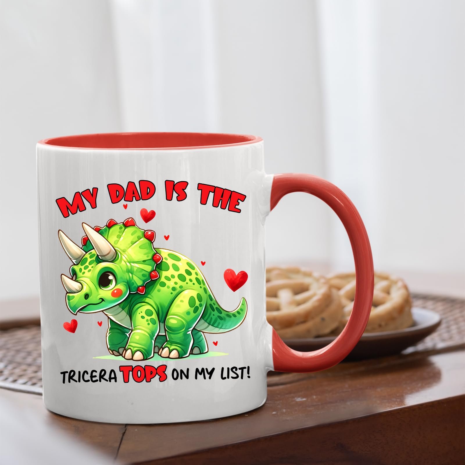 717siho0skl.jpg Triceratops dad mug with a red handle beside biscuits