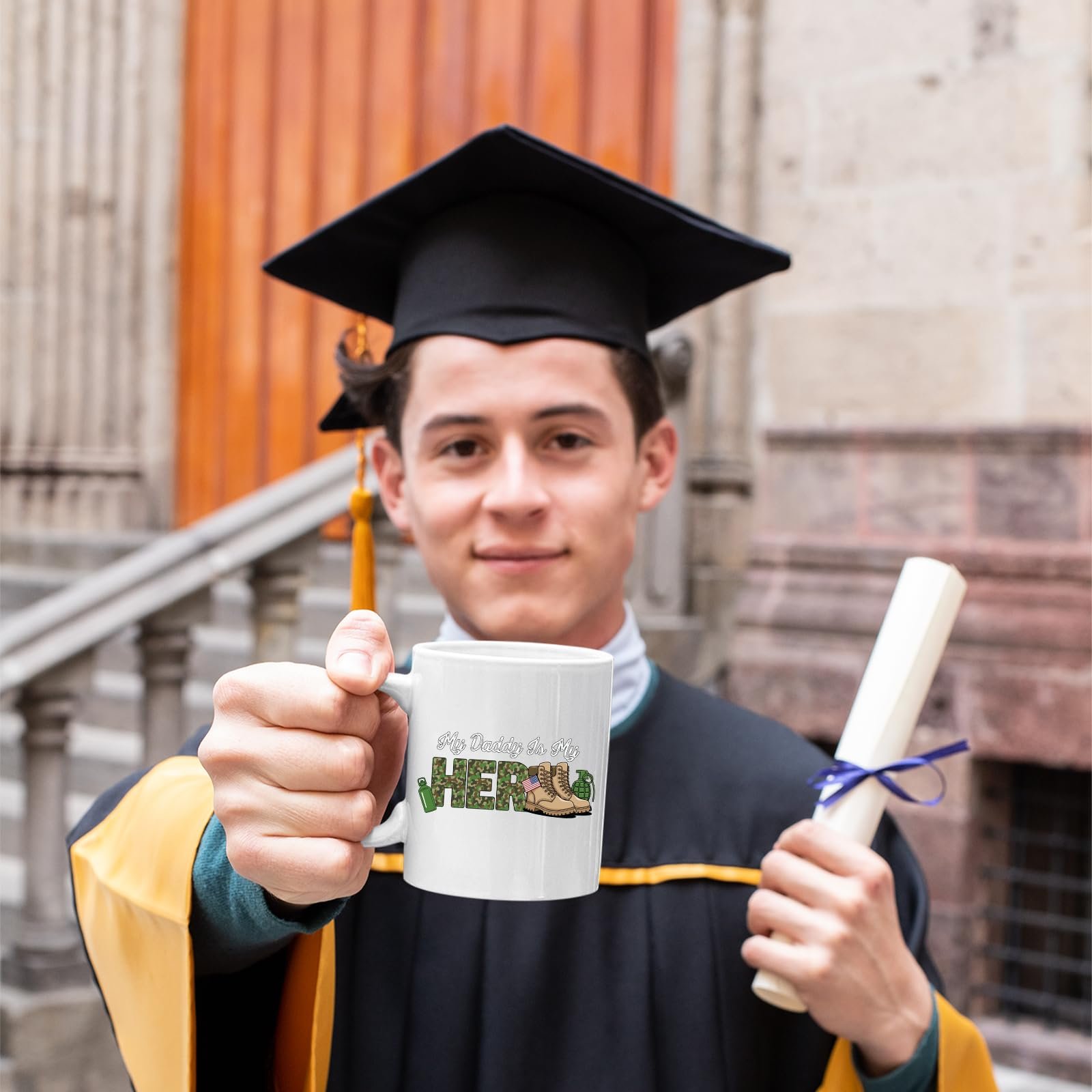71cqvlz7d l.jpg Graduate in cap and gown holding the My Daddy Is My Hero military mug