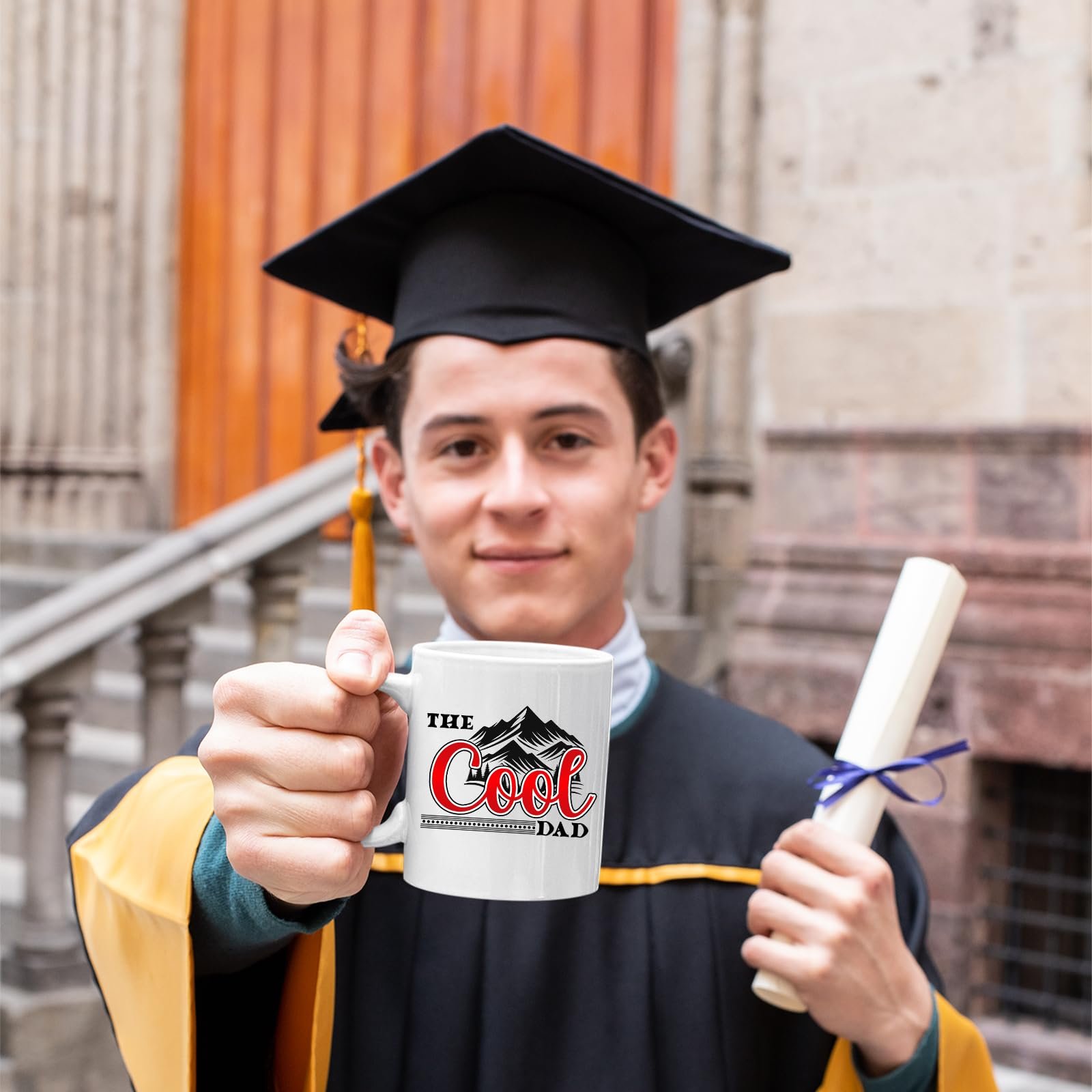 71jjvibpxel.jpg Graduate in cap and gown holding the The Cool Dad mountains mug