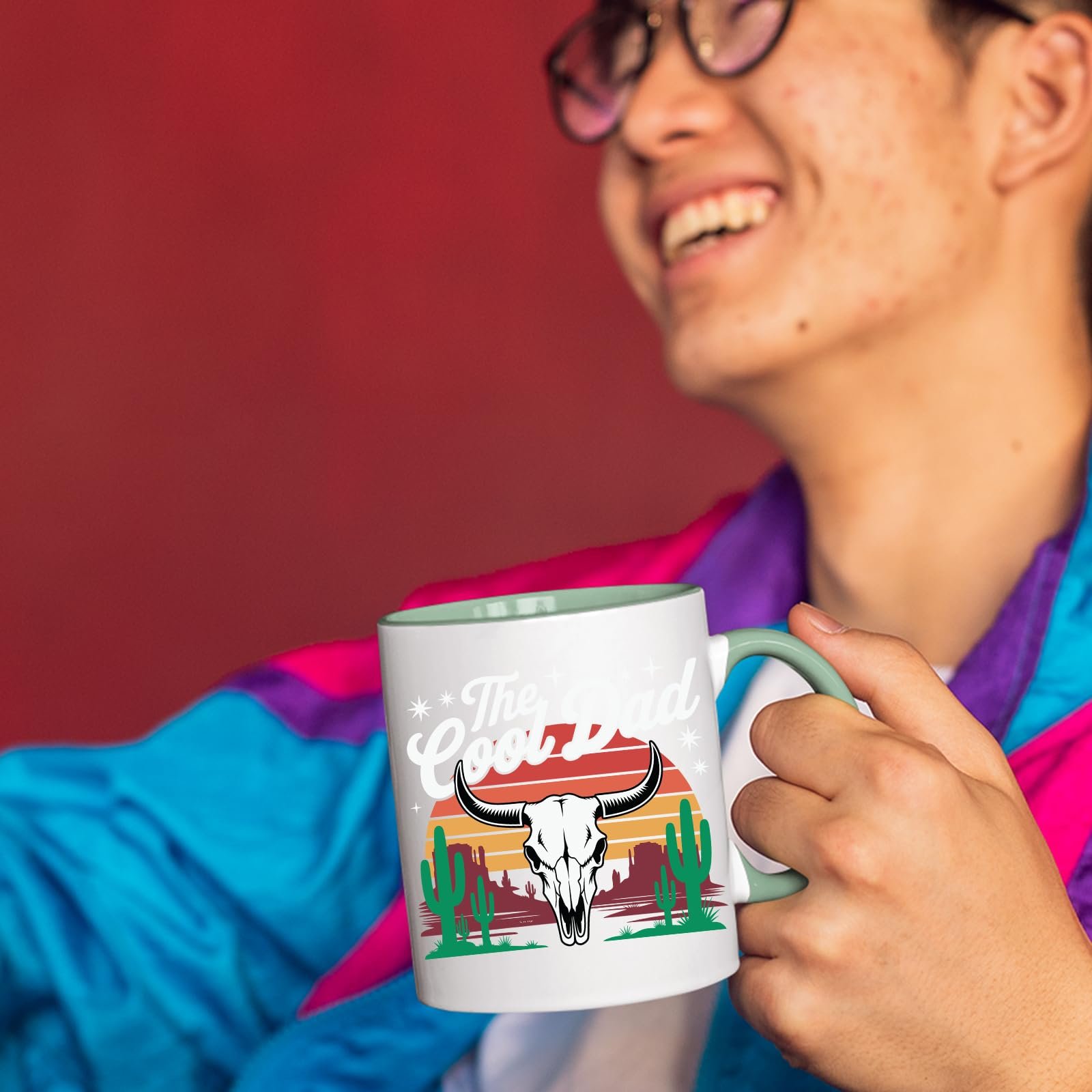 71meeorvxel.jpg Smiling person in a colourful jacket holding The Cool Dad bull skull mug with a light green handle
