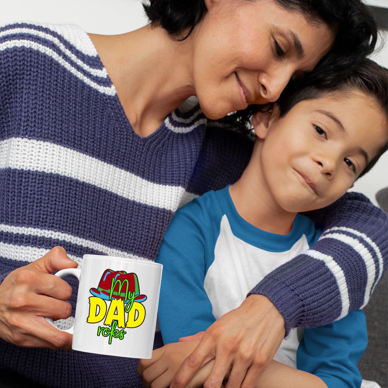 71n6 pk6eyl.jpg Mother and son cuddling with a mug with the colourful My Dad Rocks hat design