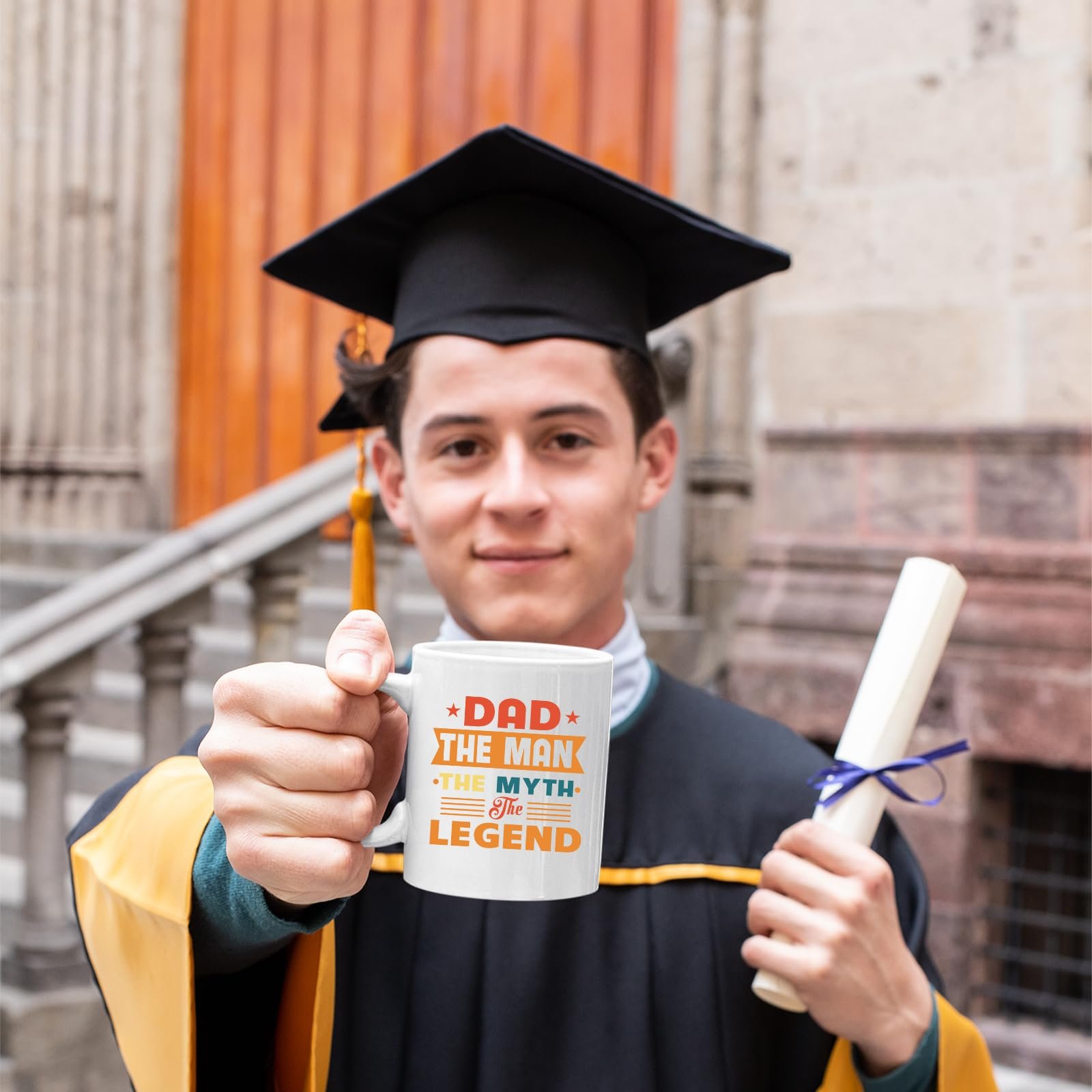 71niulybbzl.jpg Graduate in cap and gown holding the Dad the Man retro mug