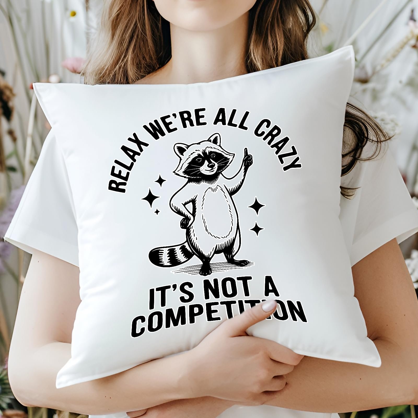 71sgg39lwpl.jpg Woman hugging the Relax We’re All Crazy raccoon cushion