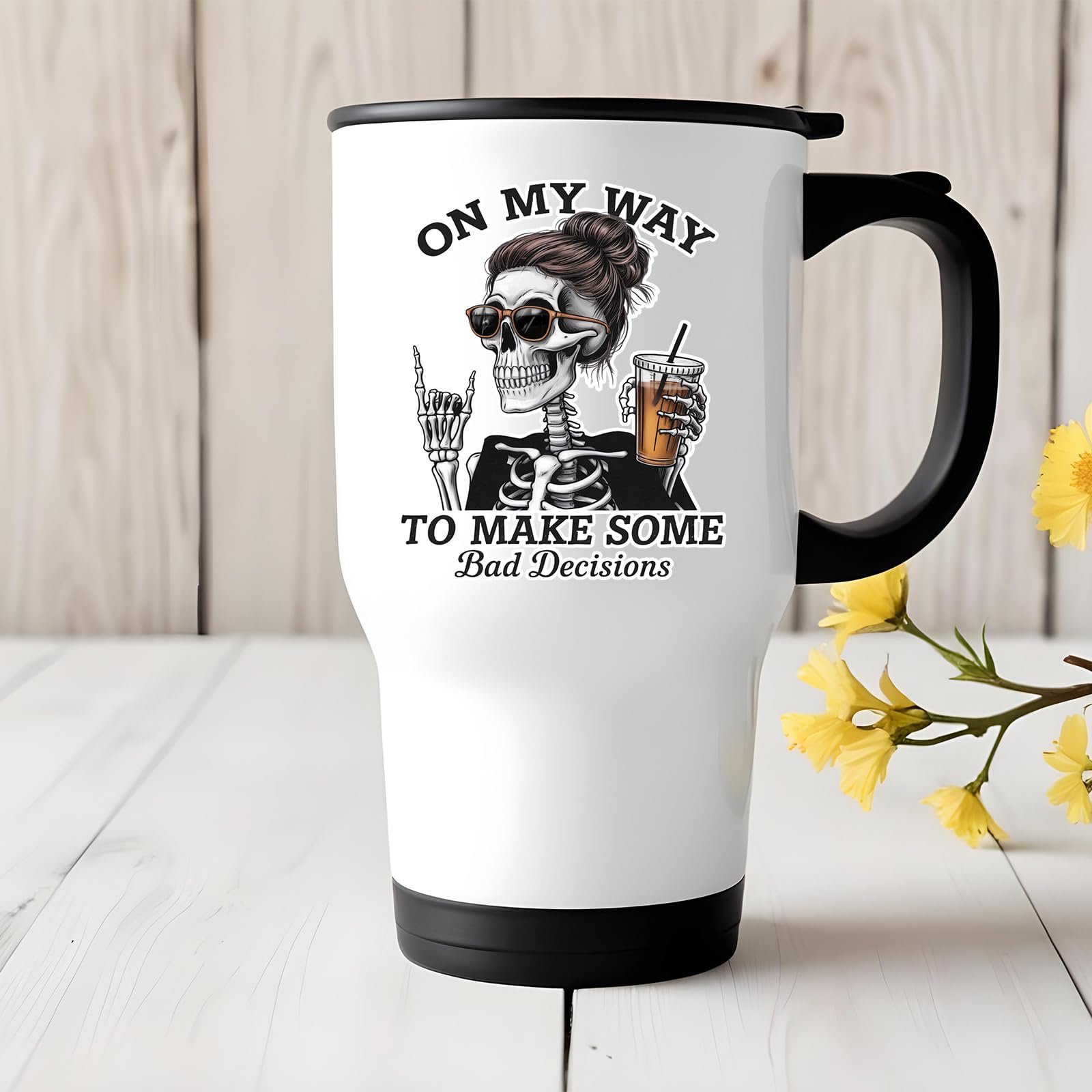 71wjmfzjs4l.jpg Bad Decisions skeleton travel mug on a white wooden table with yellow flowers