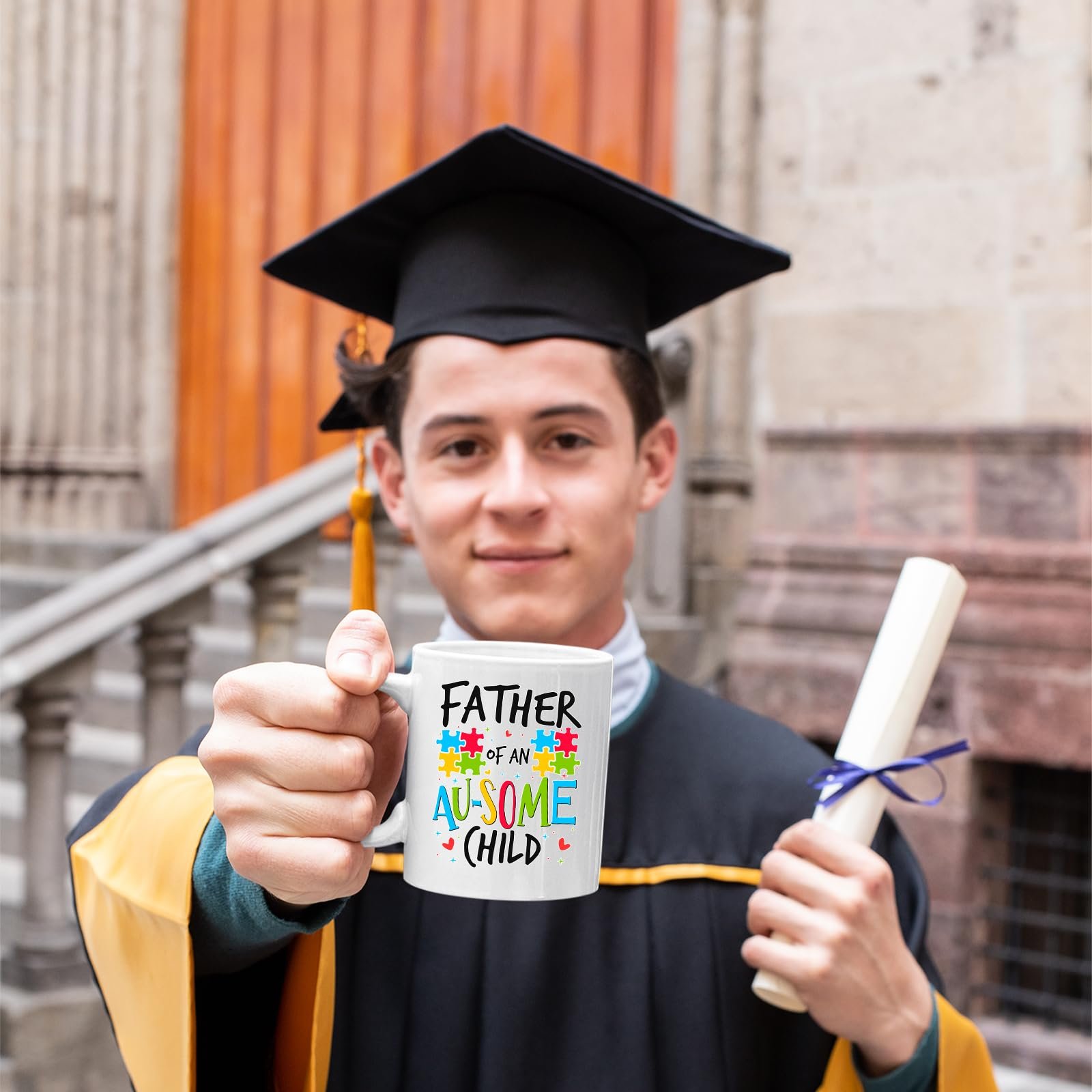 71wygjqadrl.jpg Graduate in cap and gown holding the Father of an Au-Some Child mug
