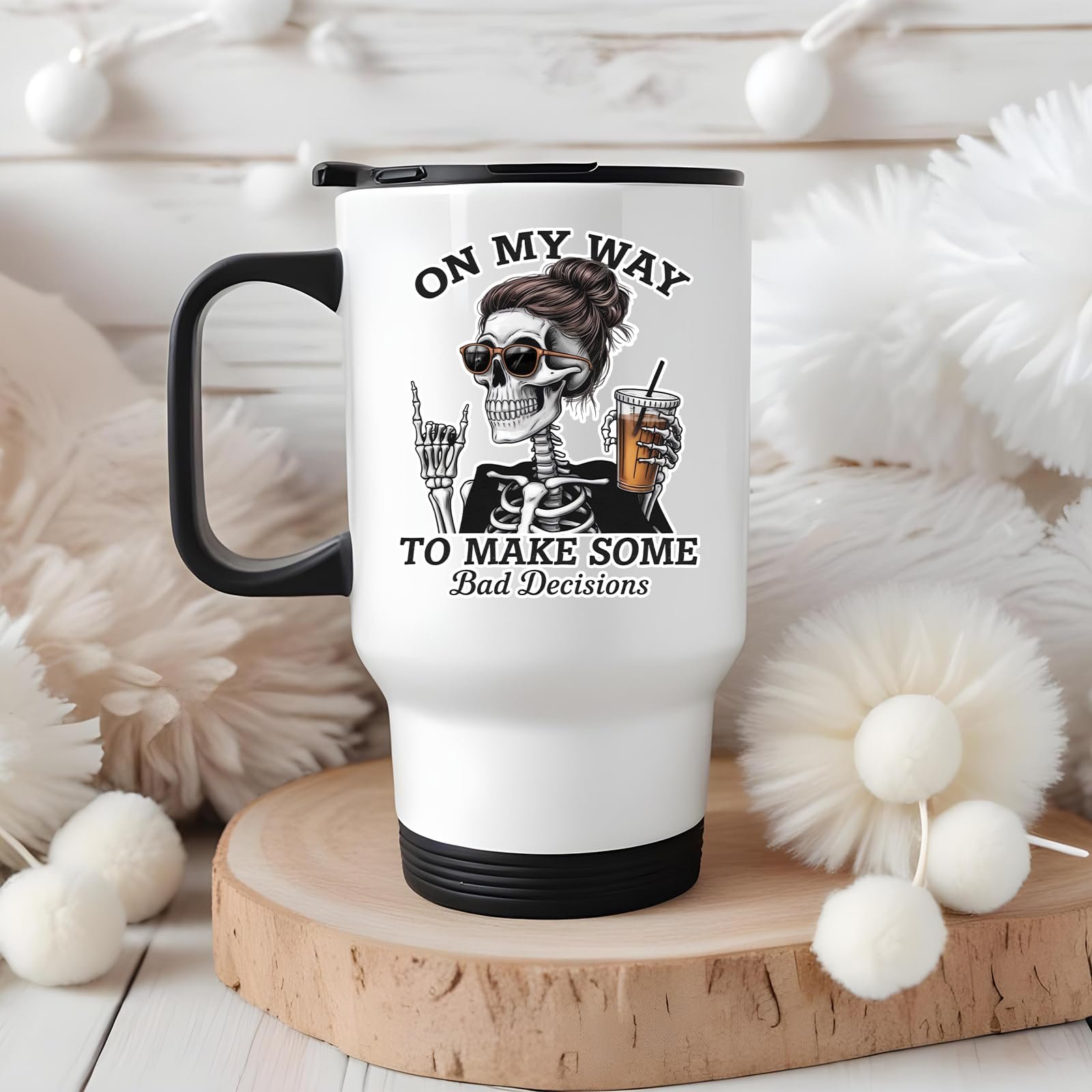 71yfmtpkm9l.jpg Bad Decisions skeleton travel mug on a wooden slice with white pom-poms
