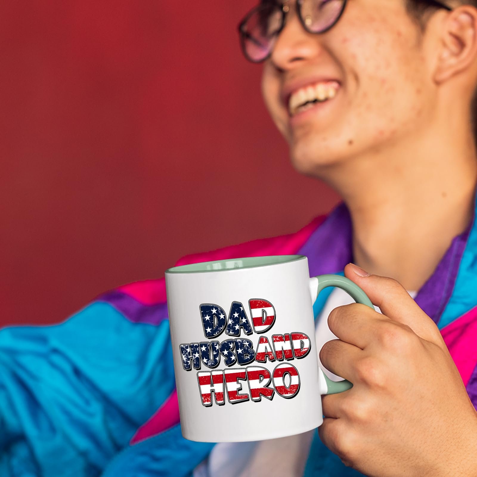71kdoimyfil.jpg Smiling person in a colourful jacket holding the Dad Husband Hero mug with a light green handle