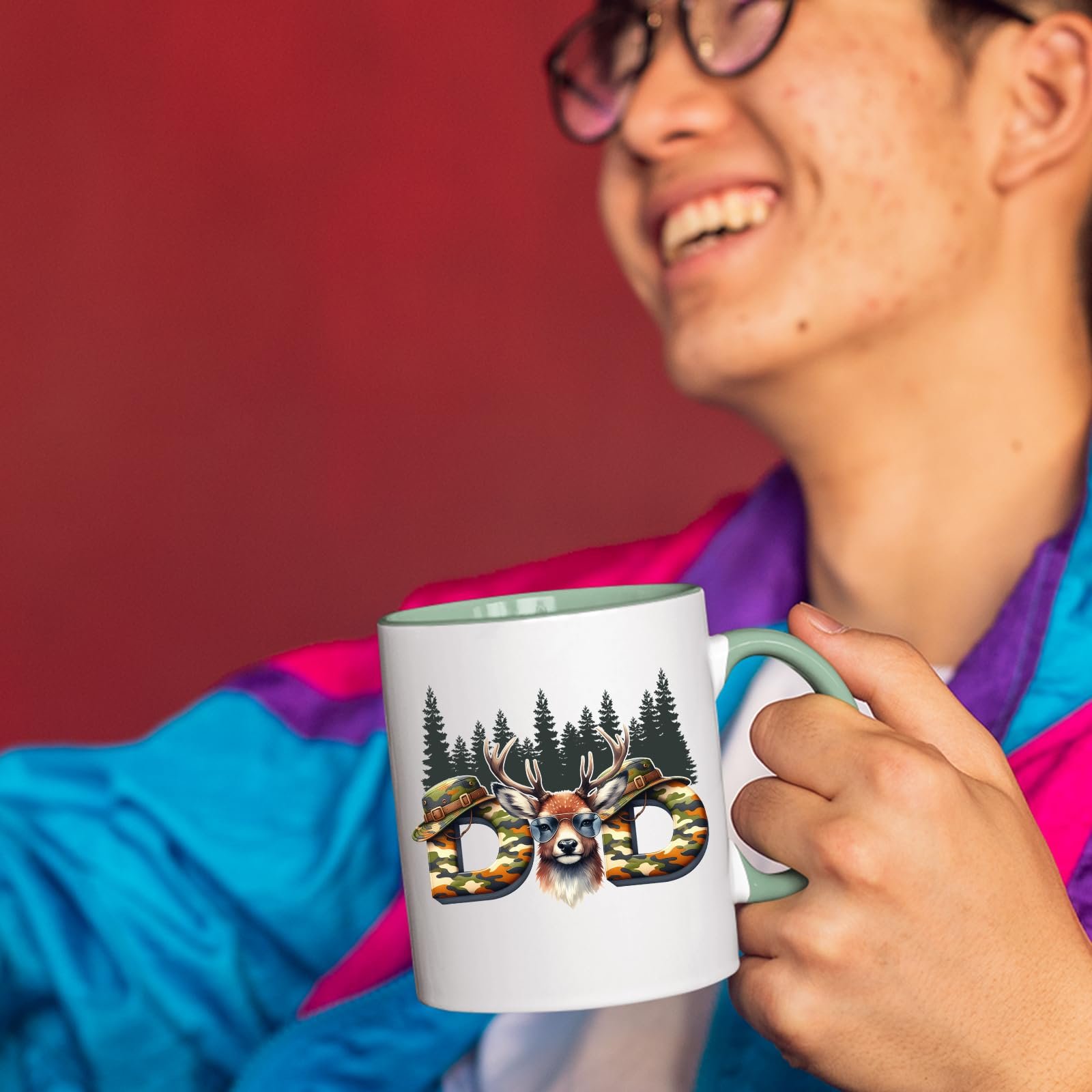 71qzpht0azl.jpg Smiling person in a colourful jacket holding the Hunting Dad deer mug with a light green handle
