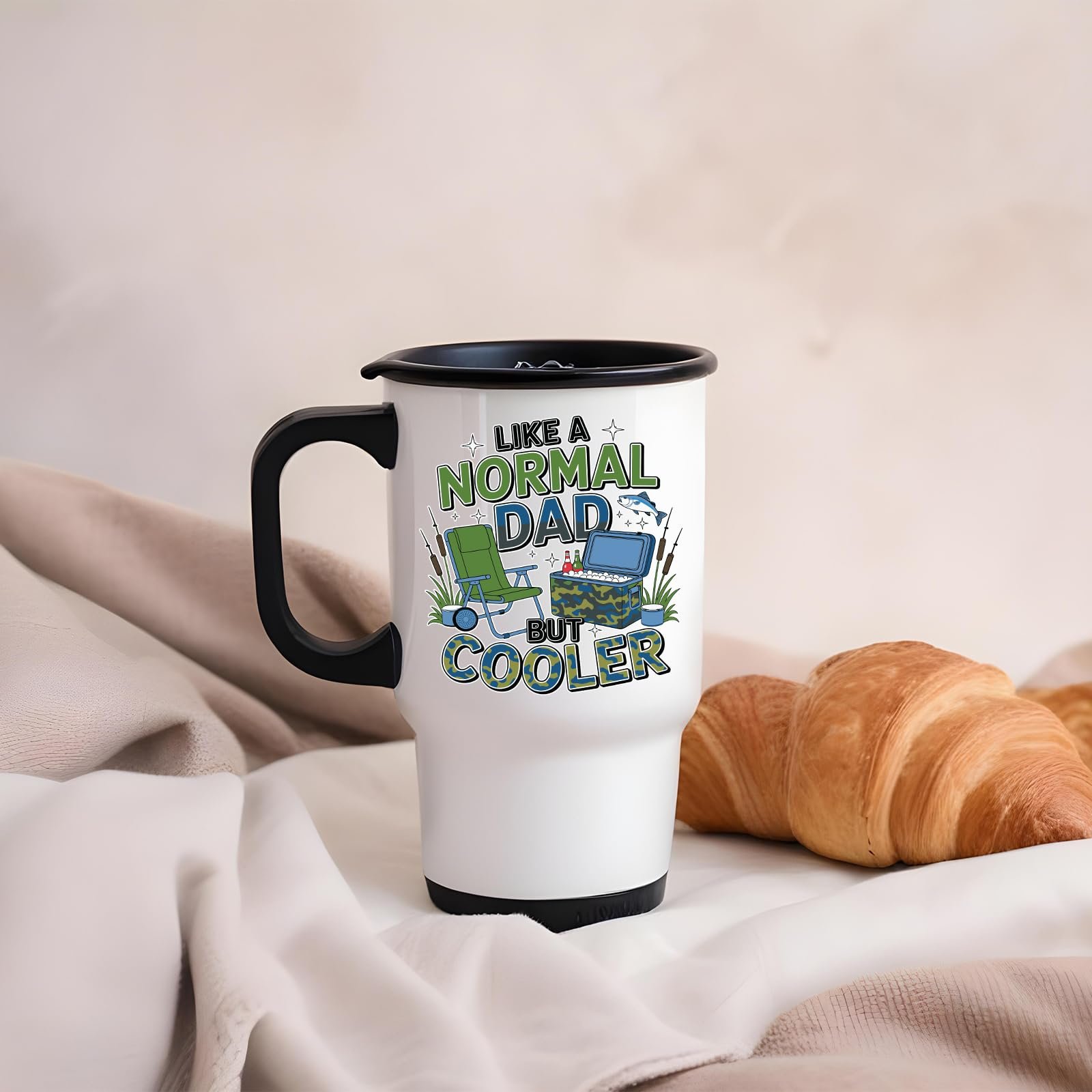 71rrcgngdkl.jpg Like a Normal Dad But Cooler travel mug on a soft blanket beside a croissant