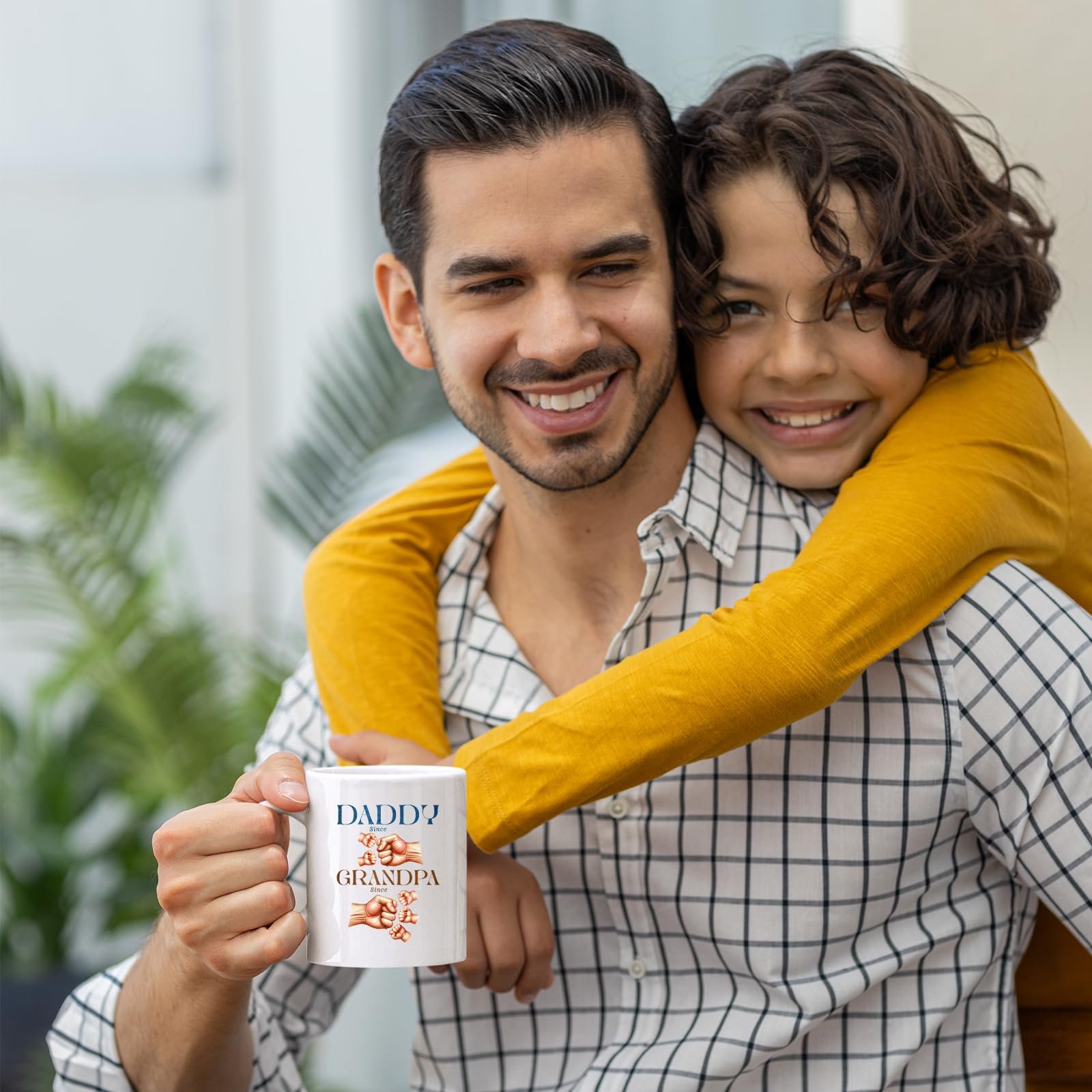 71t4wzzsi2l.jpg Smiling dad holding the Daddy and Grandpa fist bump mug as his son hugs him