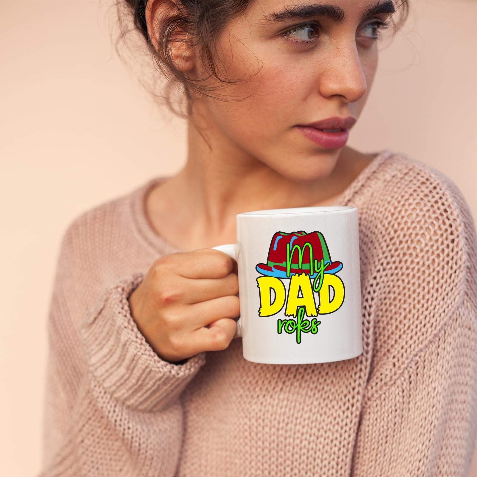 71tmkz8 ael.jpg Woman in a pink jumper holding a mug with the colourful My Dad Rocks hat design
