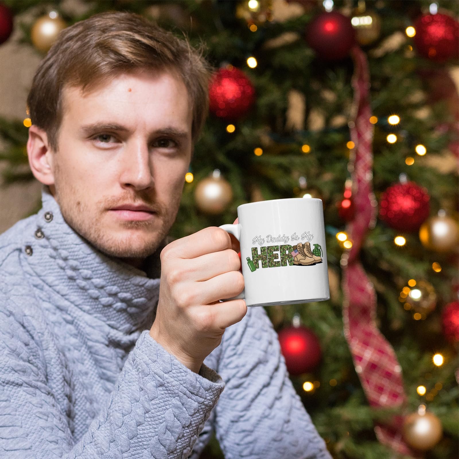 71vrvs6bstl.jpg Man holding the My Daddy Is My Hero military mug in front of a Christmas tree
