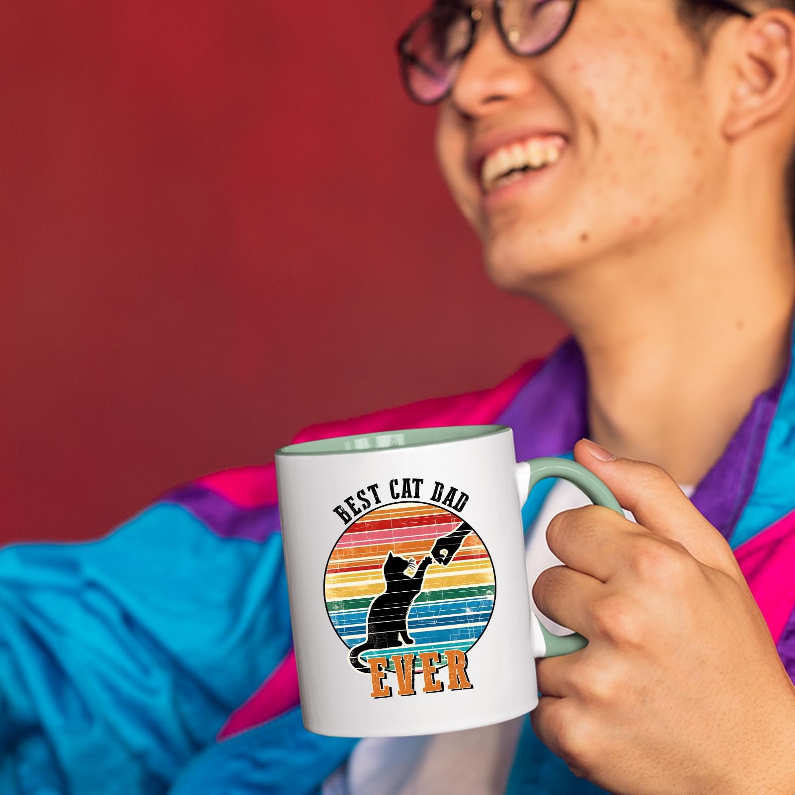 71yr4wzipal.jpg Smiling person in a colourful jacket holding the Best Cat Dad Ever mug with a light green handle