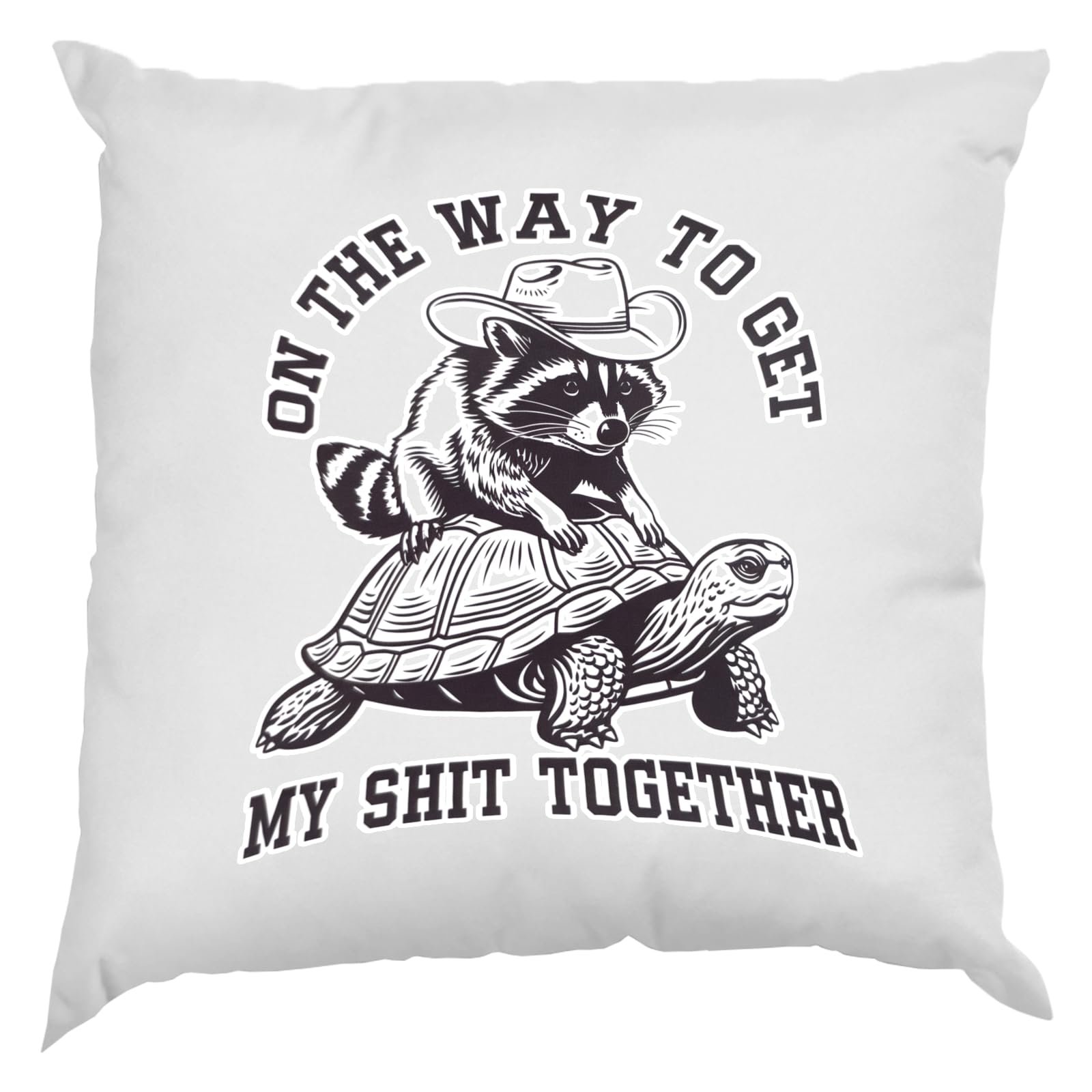 71zqdpwmktl.jpg White cushion with a raccoon in a cowboy hat riding a tortoise and “On the way to get my shit together”