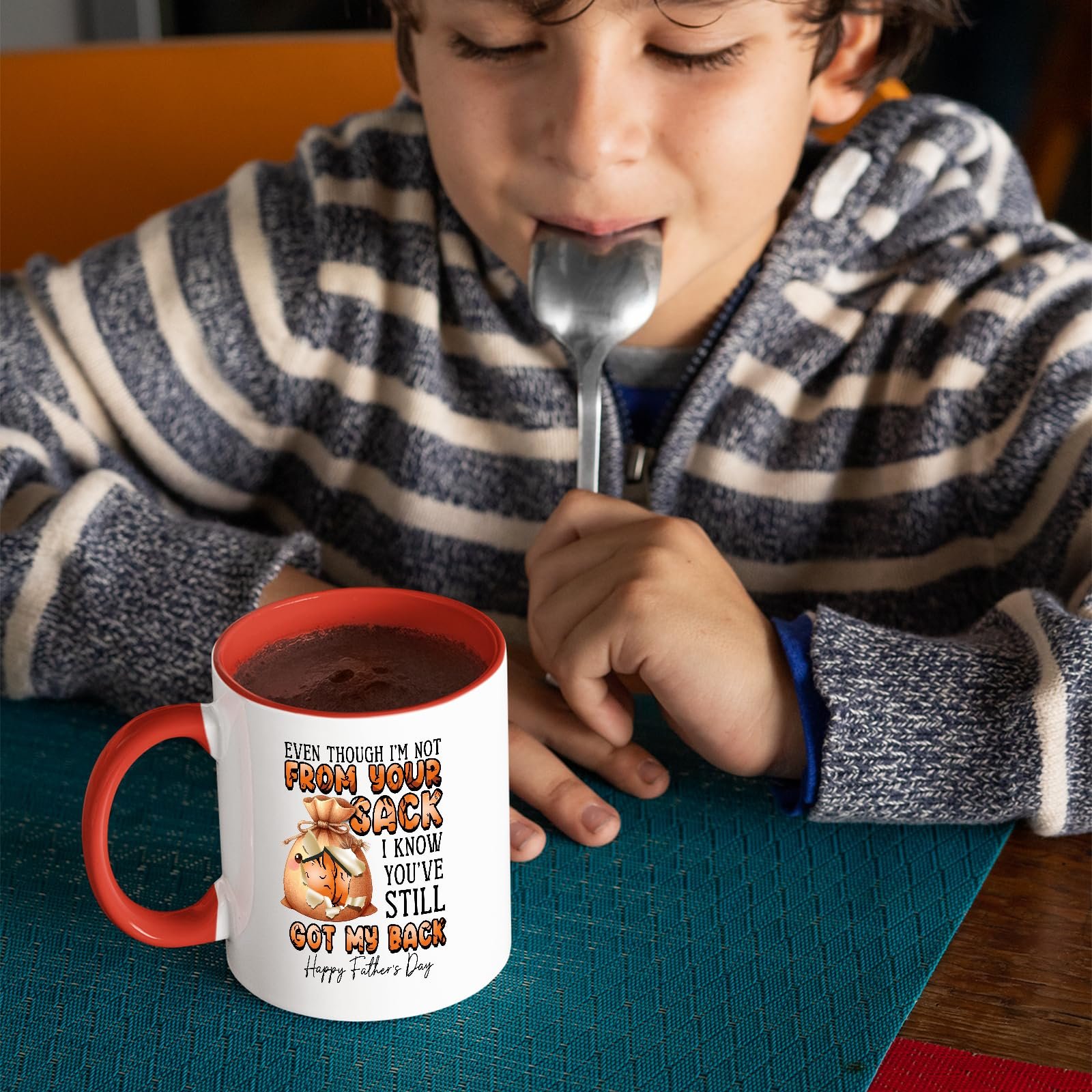 81dfvrbfqil.jpg Child with a spoon next to the Not From Your Sack mug with a red handle