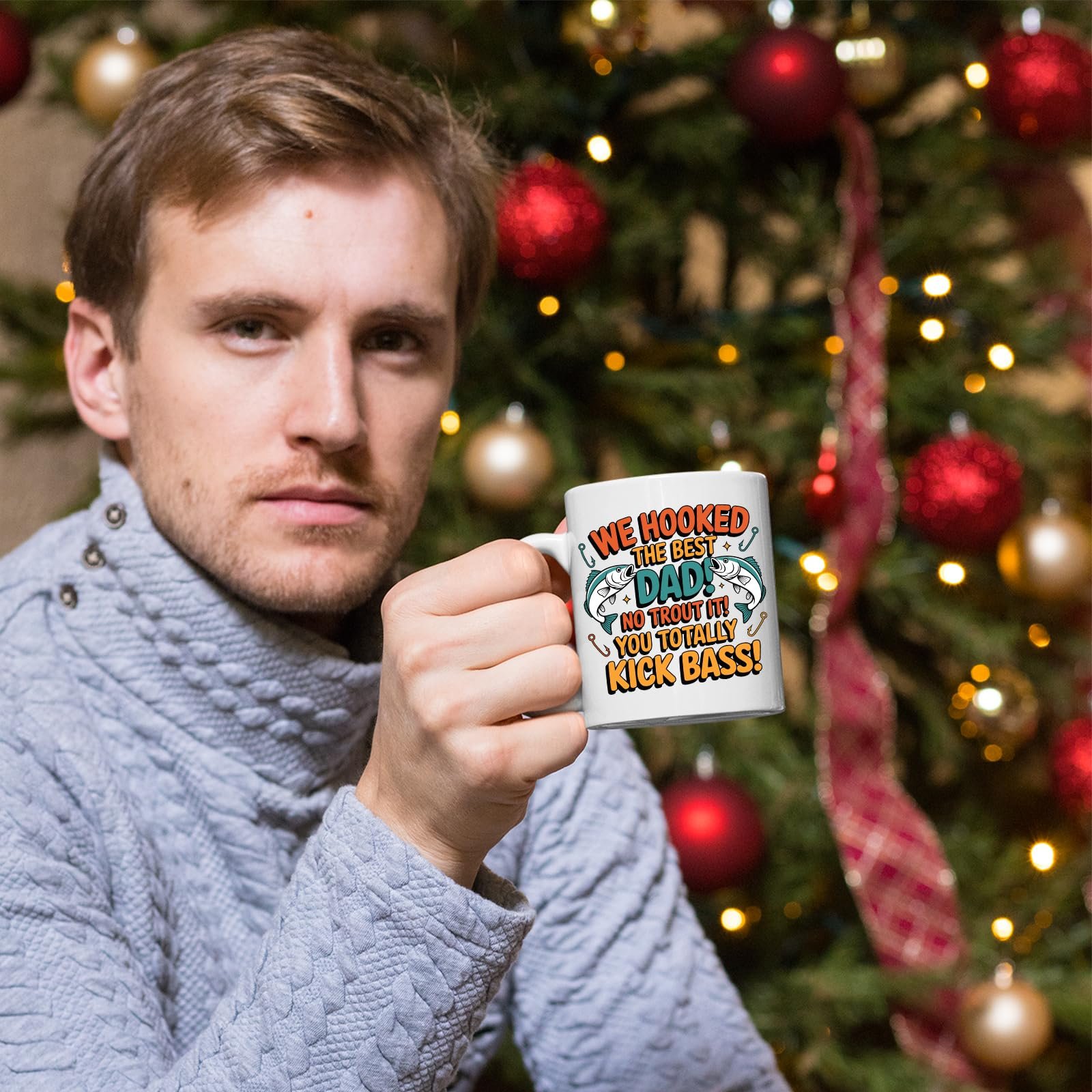81hmuwr4psl.jpg Man holding the We Hooked the Best Dad mug in front of a Christmas tree
