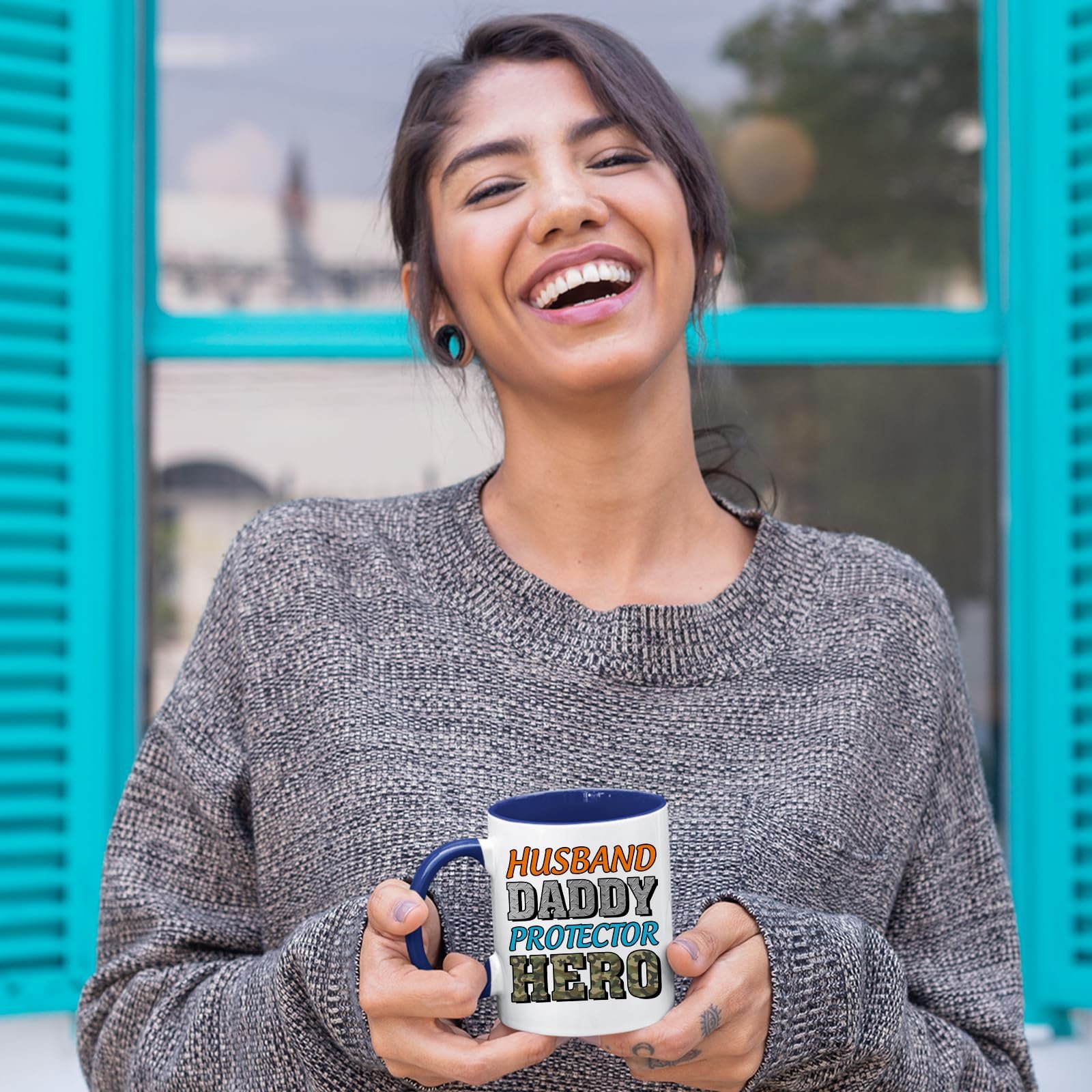 81yscrjn3nl.jpg Laughing woman holding the Husband Daddy Protector Hero camo mug with a dark blue handle